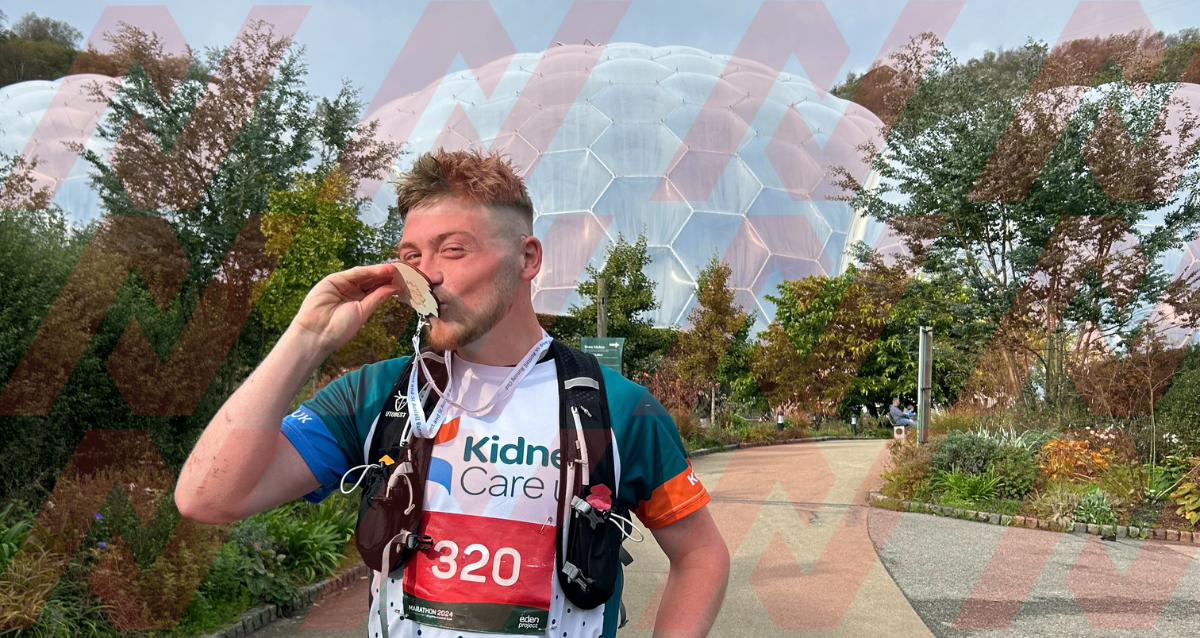 A photo of Dan with his medal in front of the iconic Eden Project bio domes. 